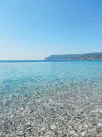 Scenic view of sea against clear blue sky