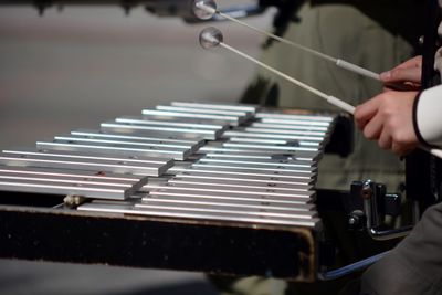 Midsection of musician playing xylophone