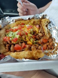 Close-up of hand holding food on table