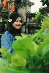 Portrait of woman standing at temple