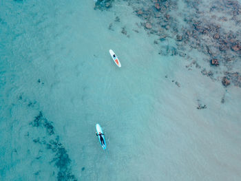 High angle view of people swimming in sea