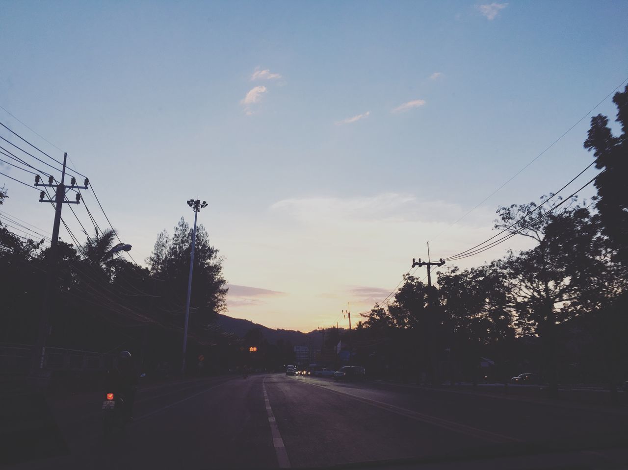 sky, transportation, road, electricity, cable, mode of transportation, nature, direction, cloud - sky, tree, connection, plant, power line, the way forward, technology, car, no people, motor vehicle, electricity pylon, diminishing perspective, outdoors, power supply