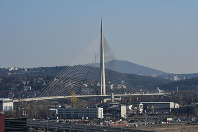 View of bridge in city against clear sky