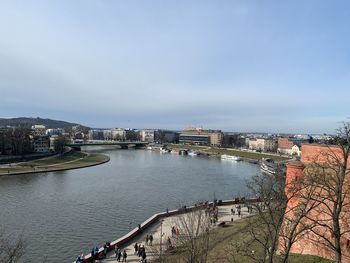 High angle view of river by buildings in city against sky