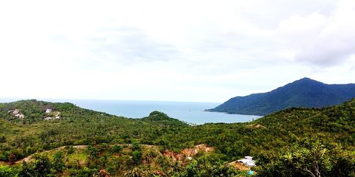 Scenic view of sea and mountains against sky