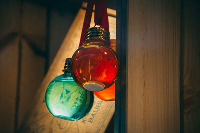 Close-up of illuminated light bulb on table