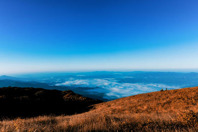 Scenic view of landscape against blue sky