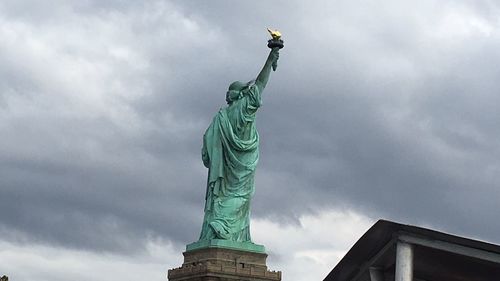 Low angle view of statue against cloudy sky