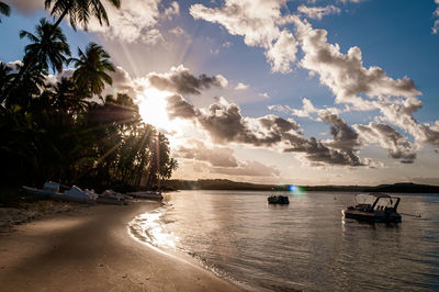 Boats moored in sea against sky