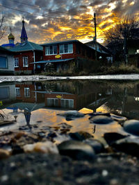 Reflection of building in puddle on street