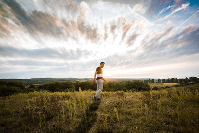 Man standing on field against sky