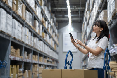 Side view of woman using mobile phone