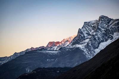 Scenic view of snow mountains against clear sky