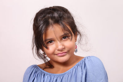 Portrait of cute girl against white background