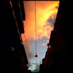 Low angle view of building against sky at sunset