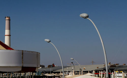 Low angle view of street lights against clear sky