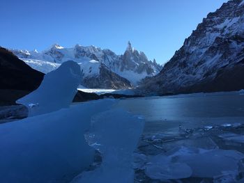 Frozen lake against snowcapped mountains