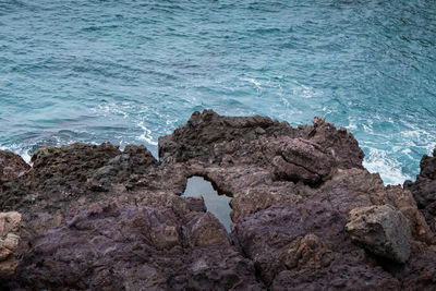 High angle view of rock formation in sea