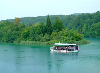 Boat sailing in lake against sky