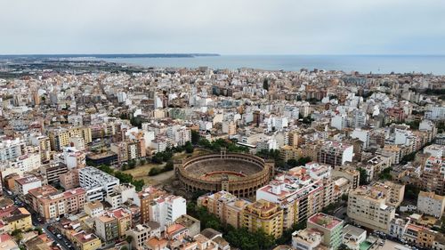 High angle view of townscape by sea against sky