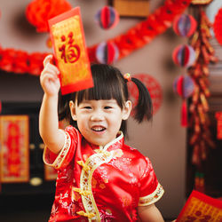 Portrait of happy girl with red umbrella