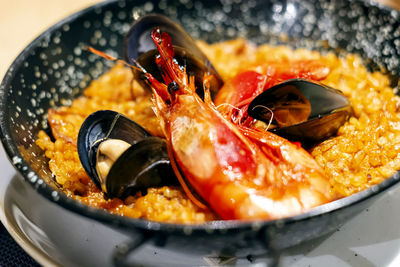 Paella with mariscos in a black pan, a typical dish of traditional spanish cuisine 