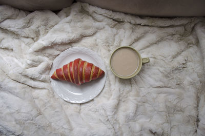 High angle view of fruit in plate on bed