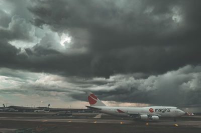 View of airplane against cloudy sky