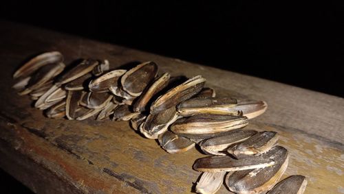 Close-up of rusty metal on table against black background