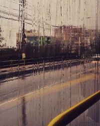 Wet road against sky during rainy season