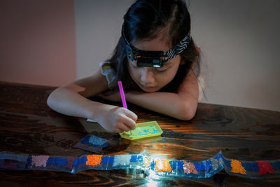 Close-up of woman drawing on table