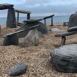 Rocks on beach against sky