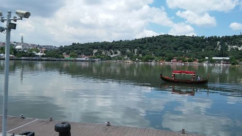 Boats moored in lake against sky