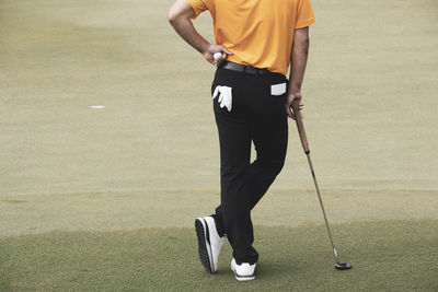 Low section of man playing with ball