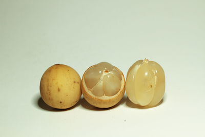 Close-up of eggs against white background