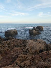 Rocks on shore against sky