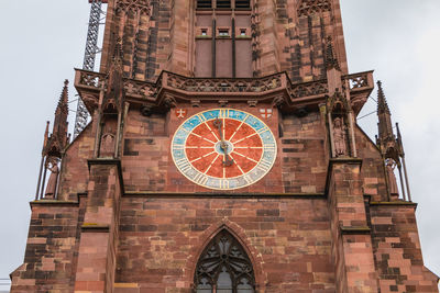 Low angle view of clock tower against building