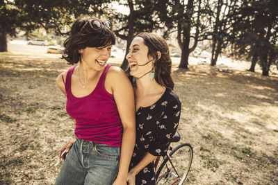 Two happy young women on bicycle