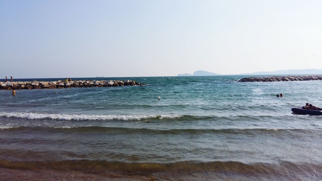 sea, water, clear sky, copy space, beach, horizon over water, scenics, nautical vessel, tranquil scene, shore, tranquility, beauty in nature, nature, transportation, incidental people, mode of transport, boat, idyllic, wave, sand