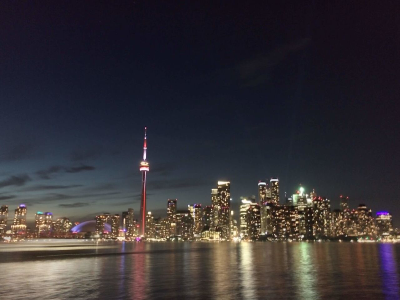 ILLUMINATED BUILDINGS AT WATERFRONT