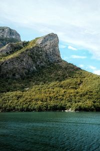 Scenic view of sea and mountains against sky