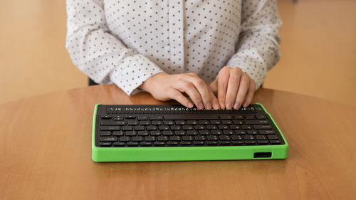 Midsection of woman using laptop