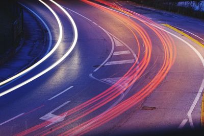 High angle view of light trails on road at night