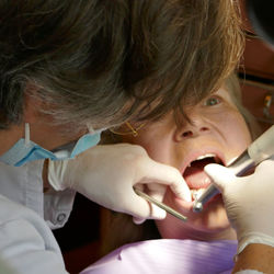 Close-up of dentist examining patient at clinic