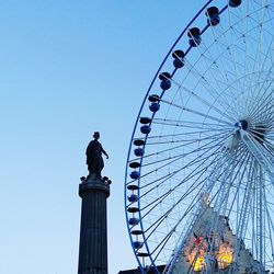 Low angle view of ferris wheel against sky