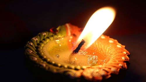 Close-up of diya against black background