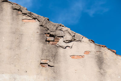 Low angle view of old building against blue sky