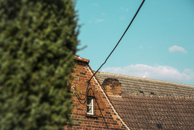 Low angle view of roof and building against sky