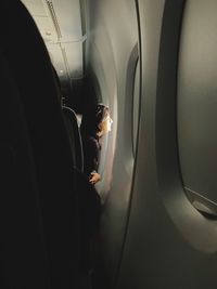 Midsection of woman sitting in airplane