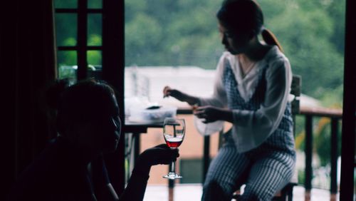 Woman holding wineglass at home